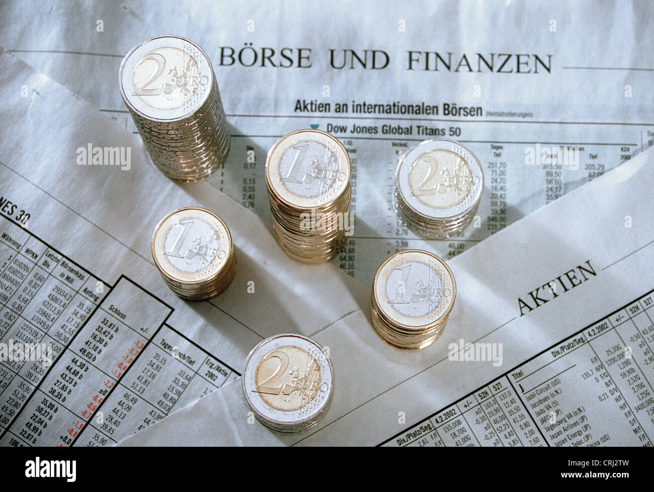 Stack of Euromuenzen on a newspaper page with stock market developments Stock Photo