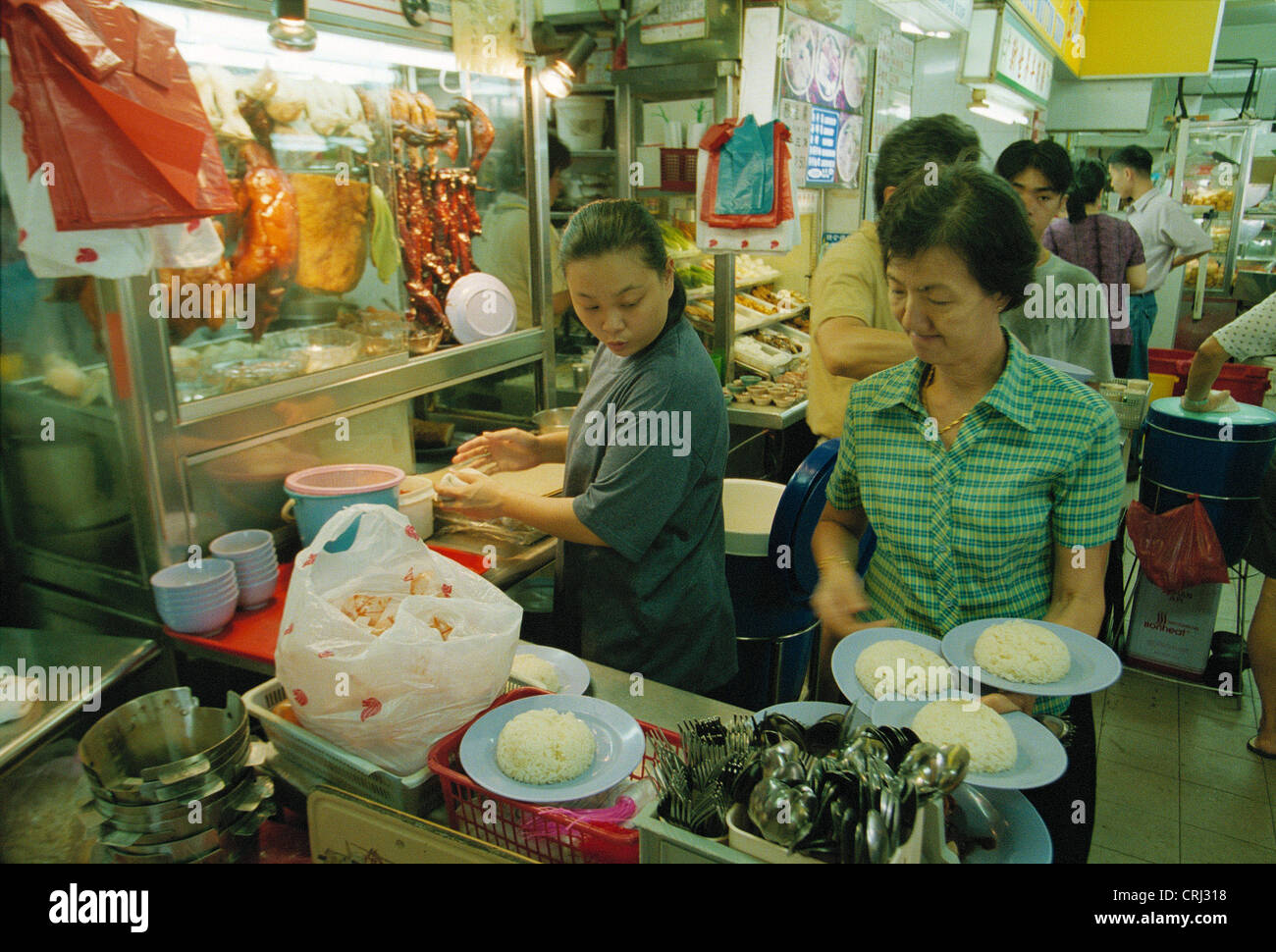 Food distribution in a Hawkerrestaurant with Chinese cuisine, Singapore Stock Photo