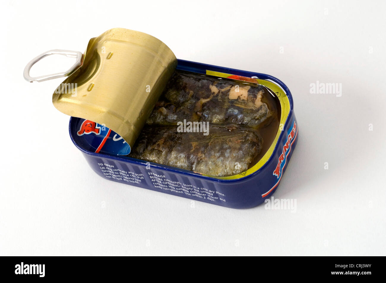 A half open can of sardines. Sardines yield rich fish oil to reduce blood pressure and the risk of heart attack. Stock Photo