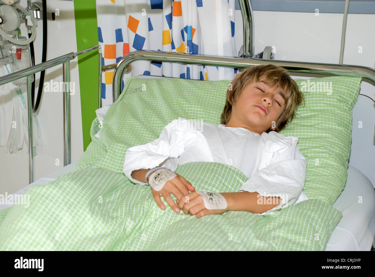 1o yeras old child lying in bed in in children hospital Stock Photo