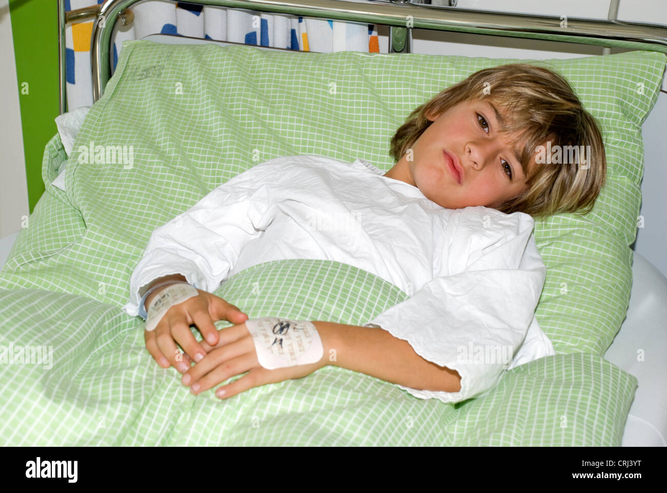 1o yeras old child lying in bed in in children hospital Stock Photo