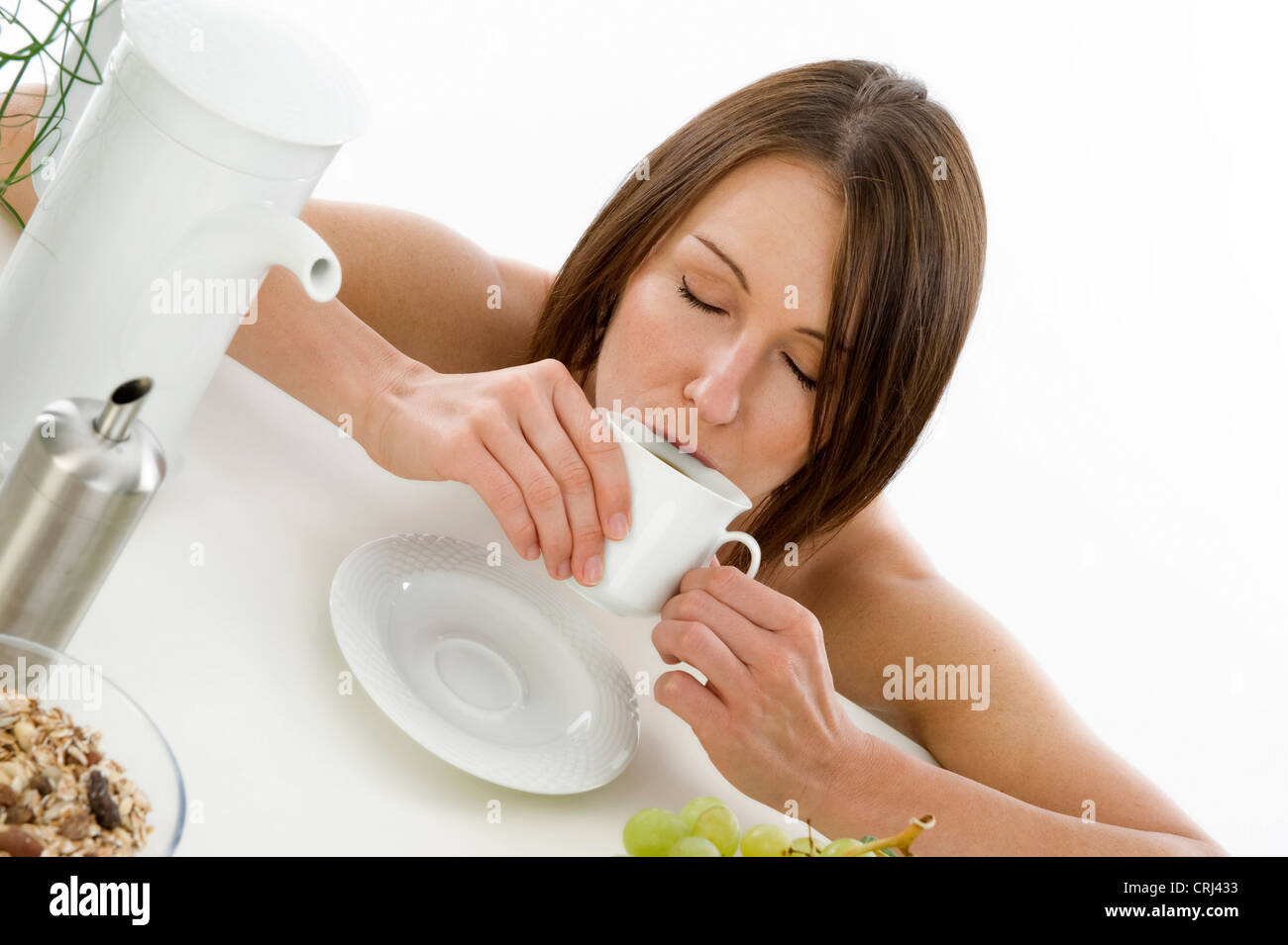 tired woman at breakfast drinking coffee Stock Photo