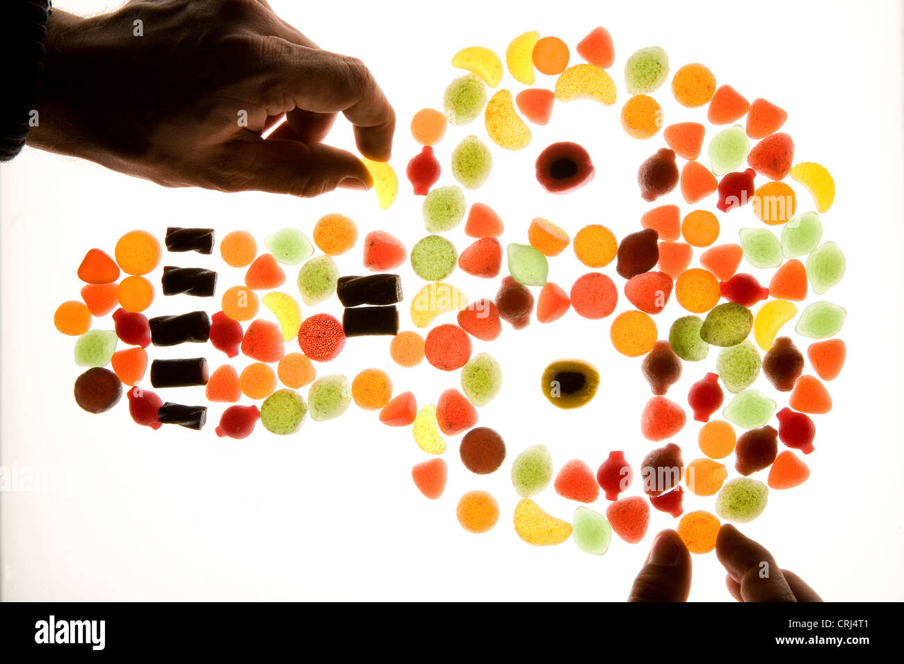An assortment of candy, being assorted into the shape of a skull Stock Photo