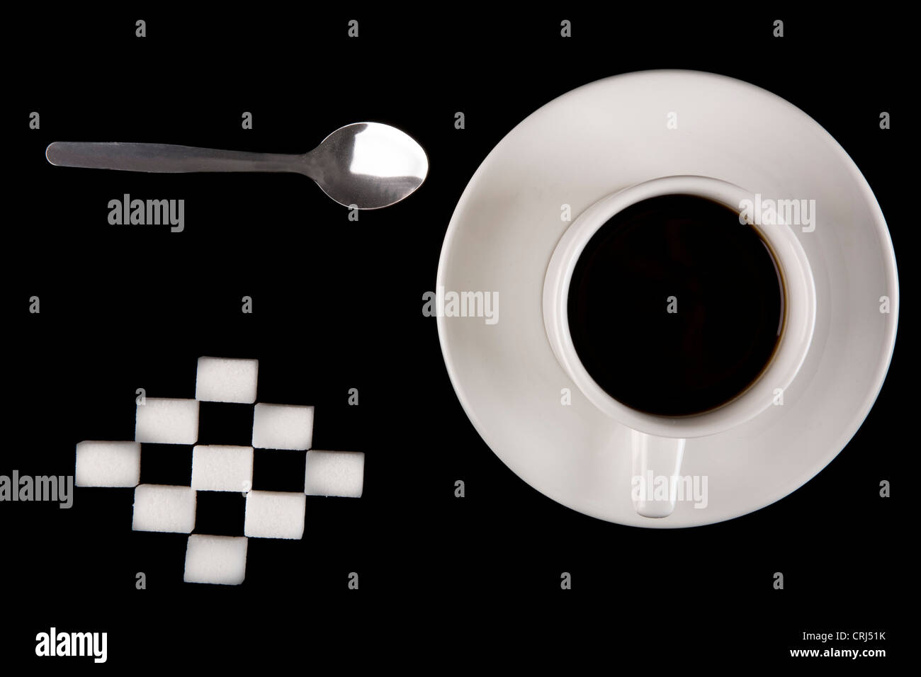 Cup of coffee, a selection of sugar cubes and a silver spoon Stock Photo