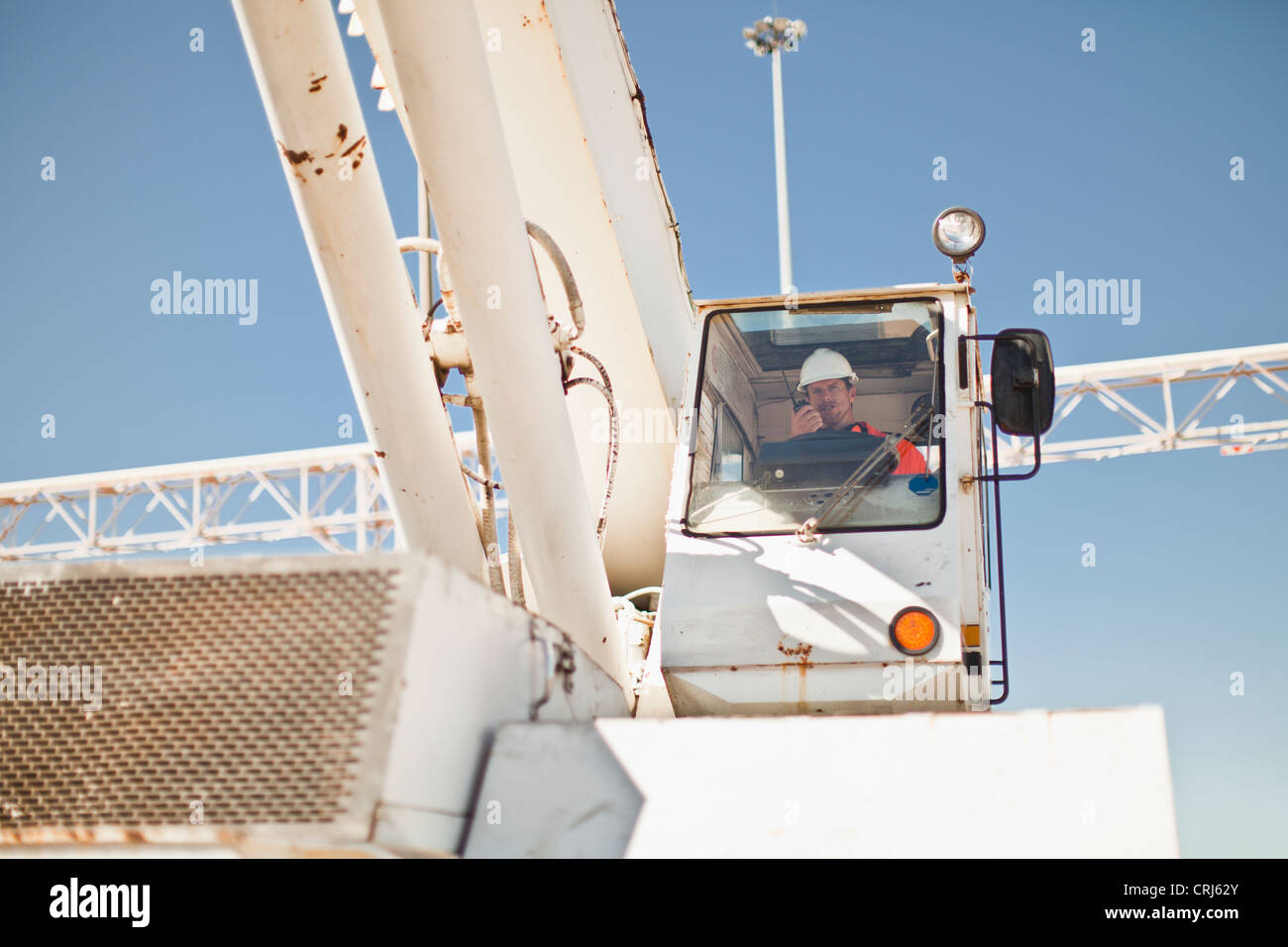 Worker operating crane at oil refinery Stock Photo Alamy