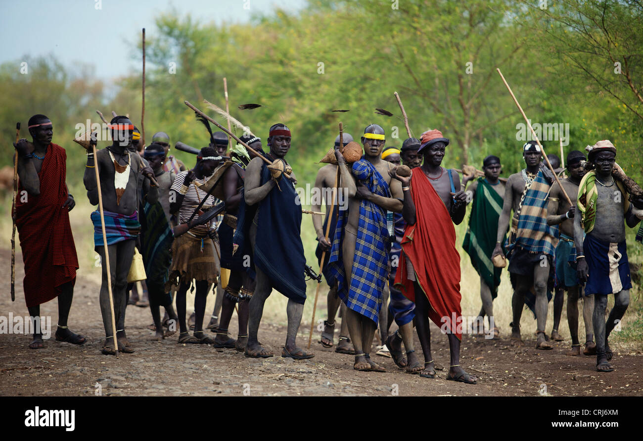 Group of Bodi carrying weapons and stones. Stock Photo
