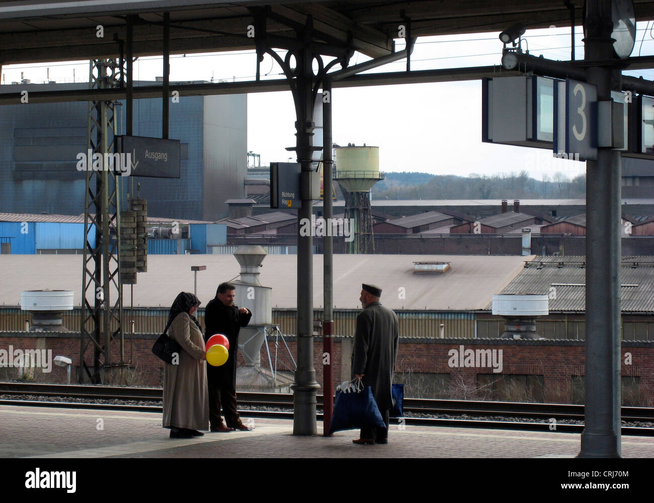 three Muslims at main station, steelwork in the background, Germany, North Rhine-Westphalia, Ruhr Area, Witten Stock Photo