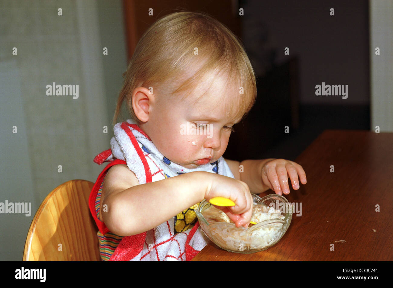 A toddler eats his Muesli Stock Photo Alamy