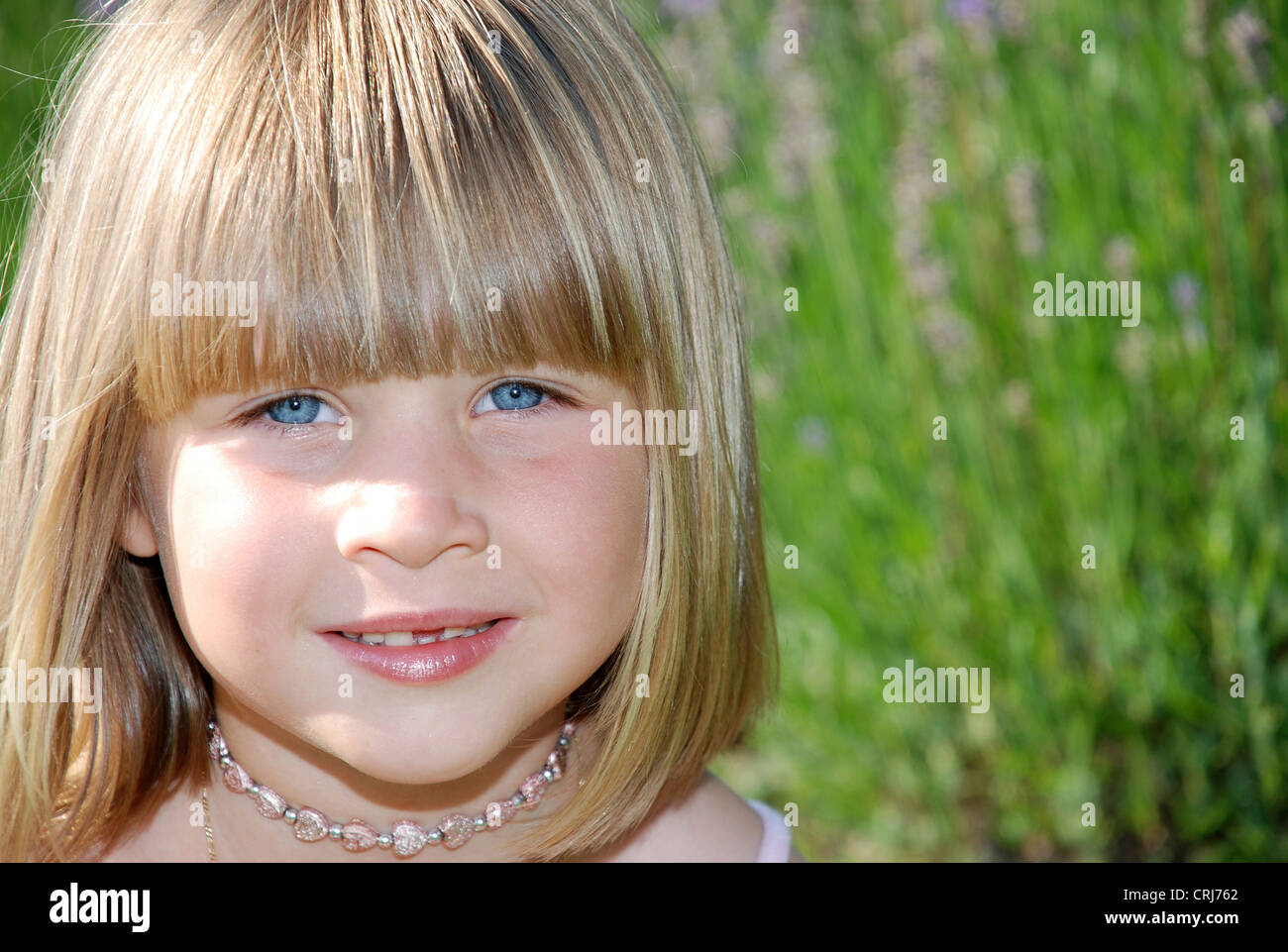 Little girl with with straight blond hair in pageboy style 