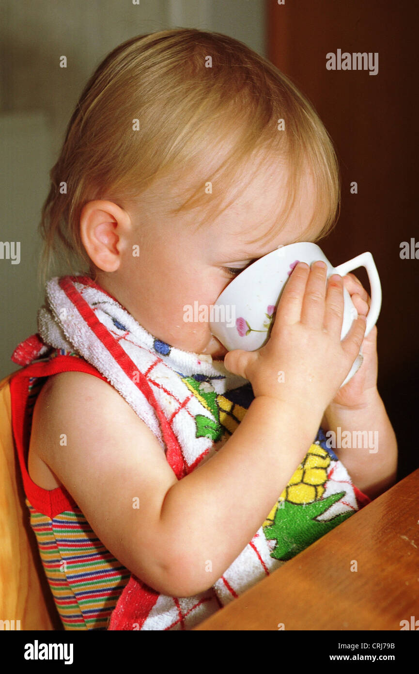 A toddler drinking from a cup Stock Photo Alamy