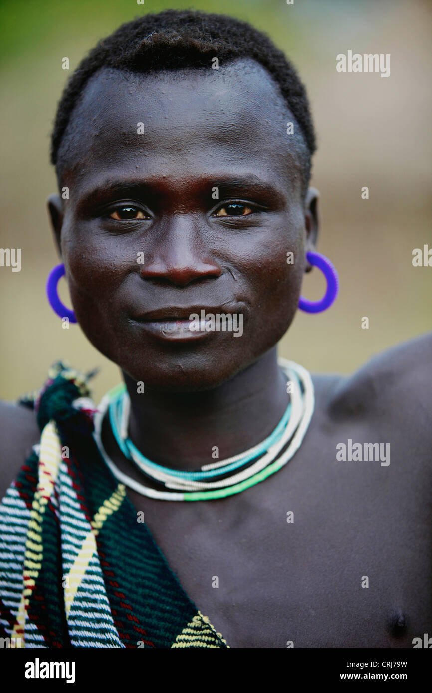 Tribal Bodi man wearing purple earrings Stock Photo