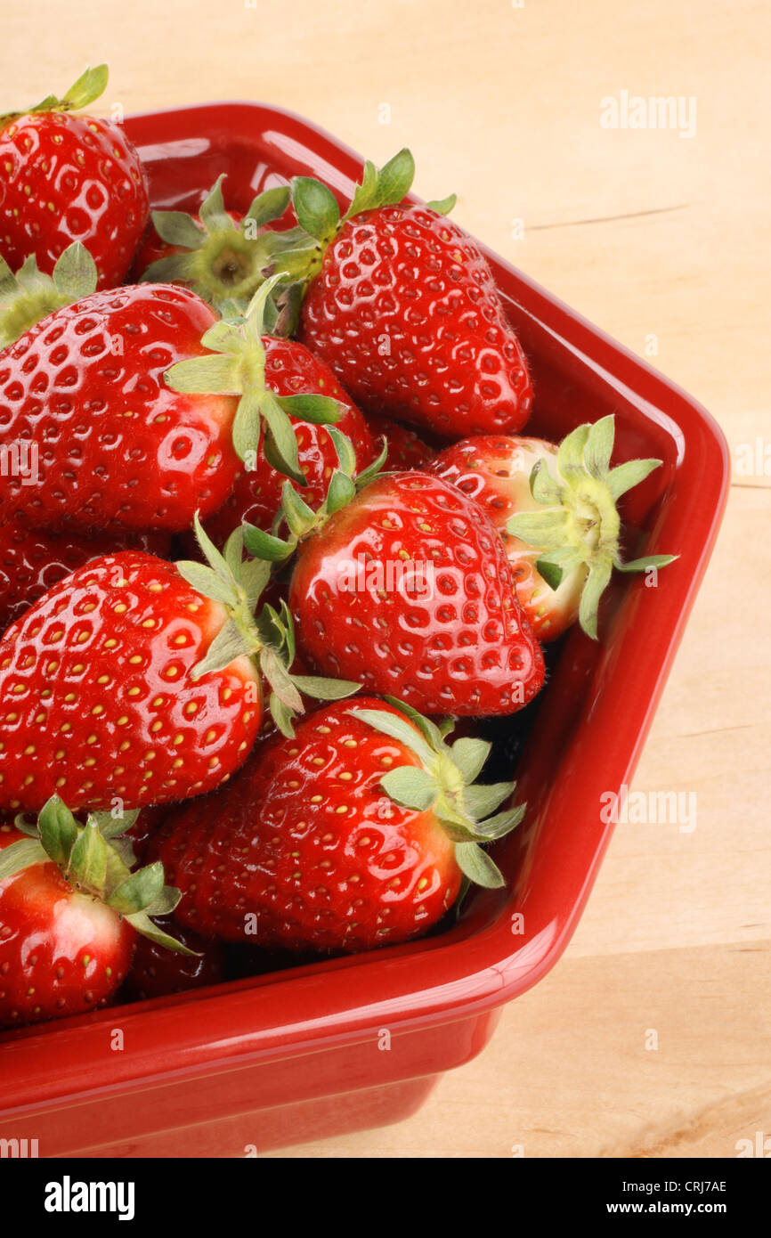 Fresh ripe strawberries in a red bowl over a wooden background Stock ...