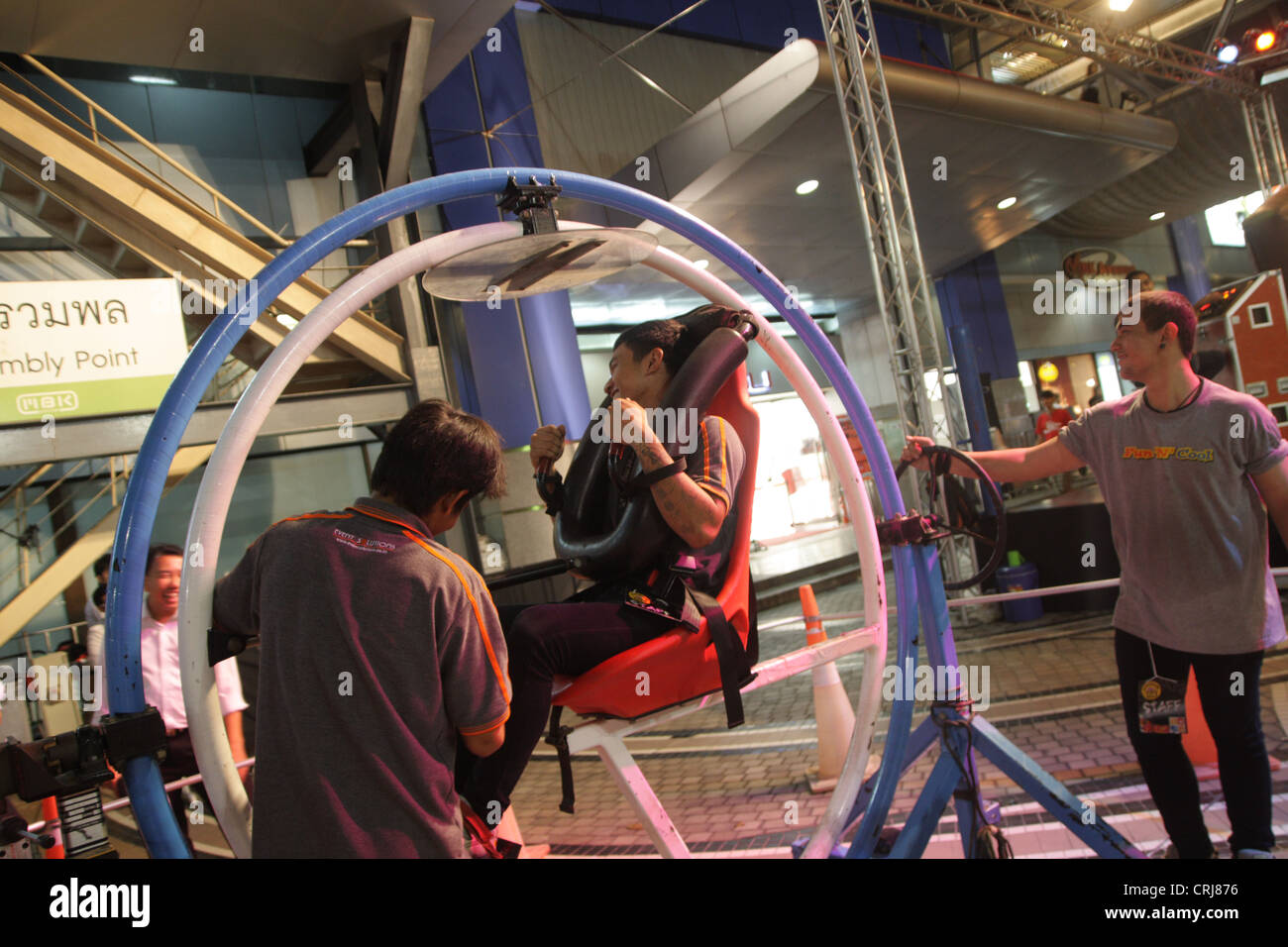 People riding on Space Roller in amusement park at MBK shopping mall in ...