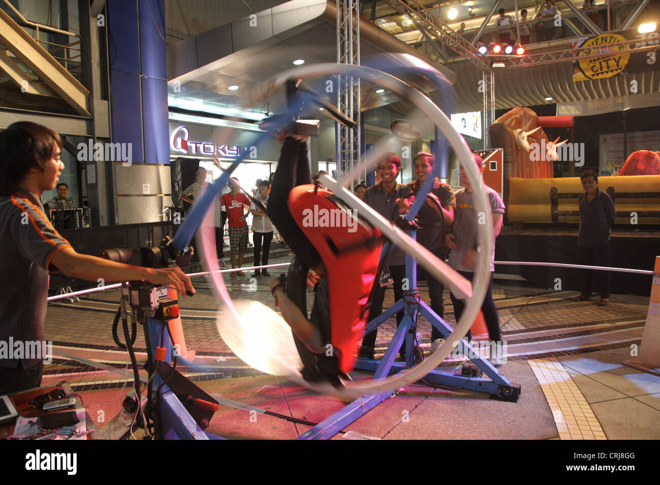 People riding on Space Roller in amusement park at MBK shopping mall in ...