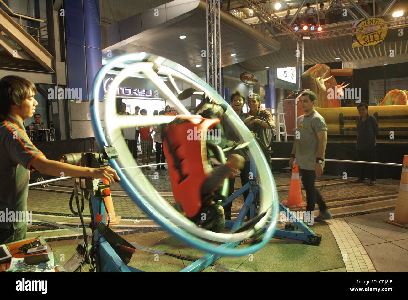 People riding on Space Roller in amusement park at MBK shopping mall in ...