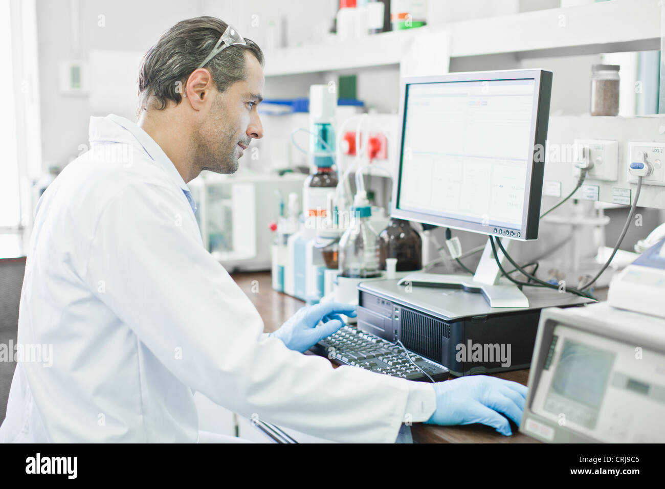 Scientist using computer in lab Stock Photo