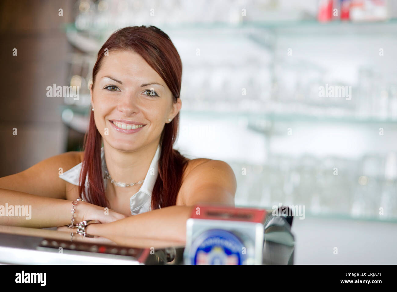 young barmaid behind the bar Stock Photo