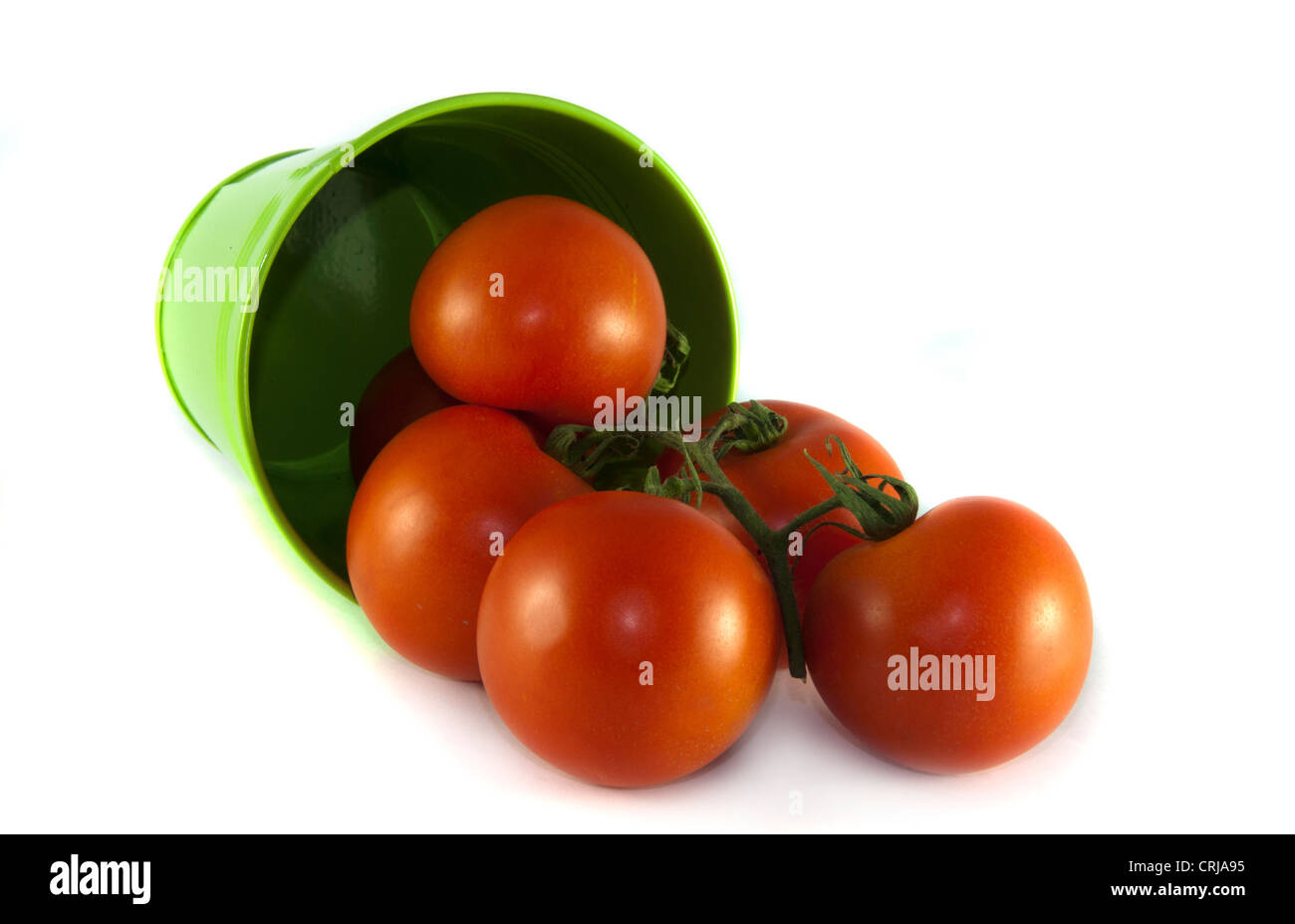 green container with red tomatoes on isolated white background Stock Photo