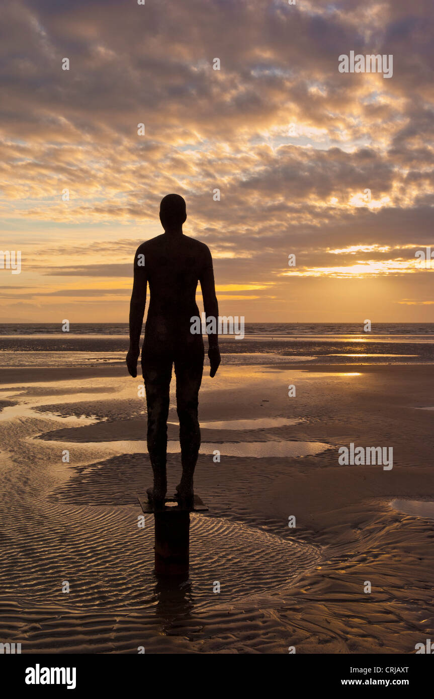 [another place] lifesize metal statues on crosby beach merseyside england uk gb eu europe Stock Photo