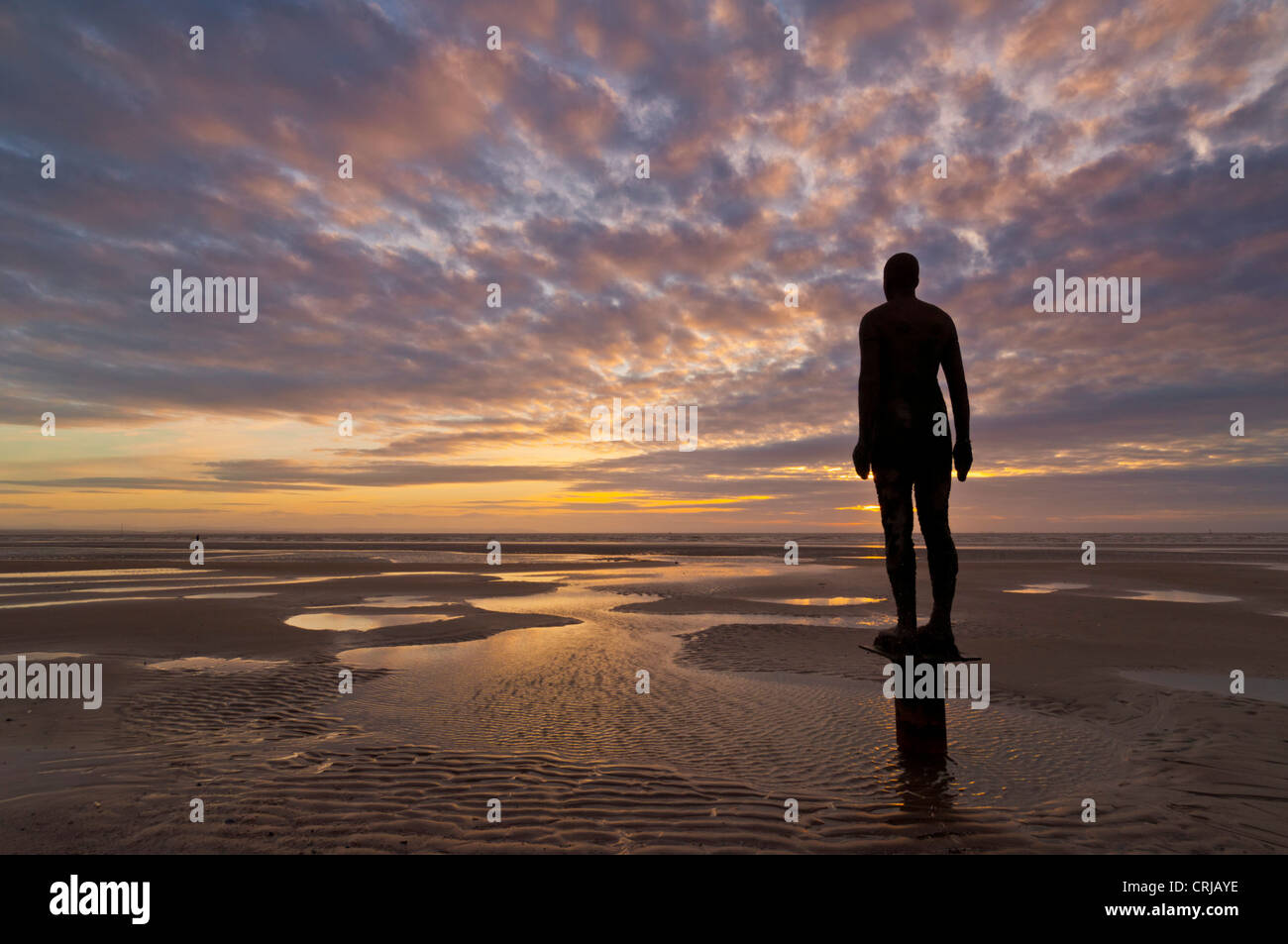 Another Place lifesize metal statues on Crosby beach by Antony Gormley