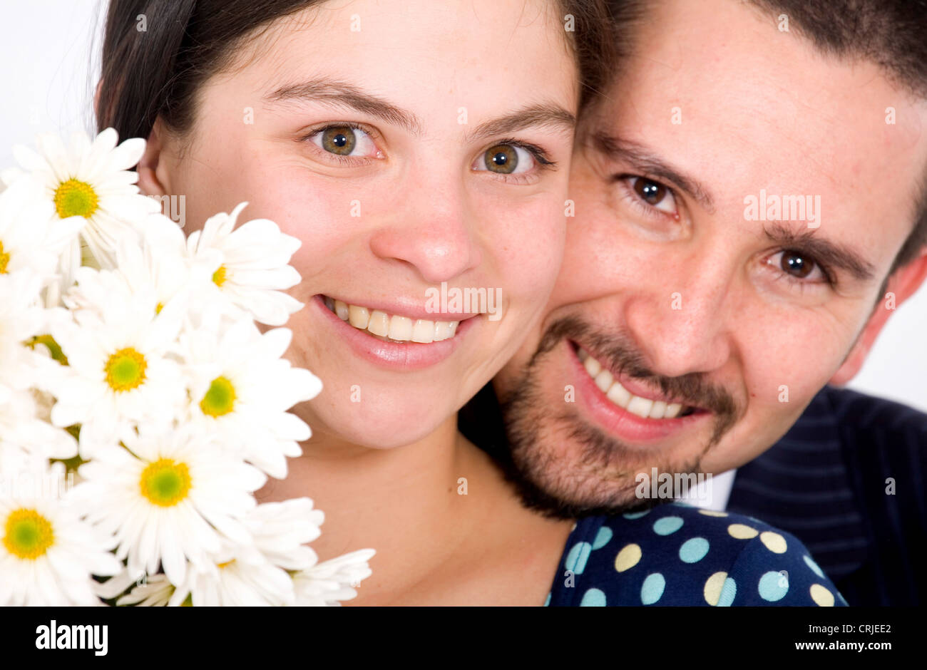 beautiful couple portrait - both smiling with white flowers Stock Photo ...