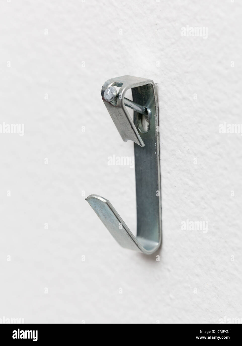 Close up of a metal picture hook nailed to plaster wall ready to mount a picture frame Stock Photo