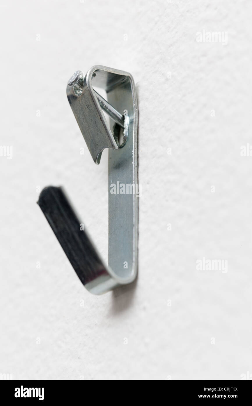 Close up of a metal picture hook nailed to plaster wall ready to mount a picture frame Stock Photo