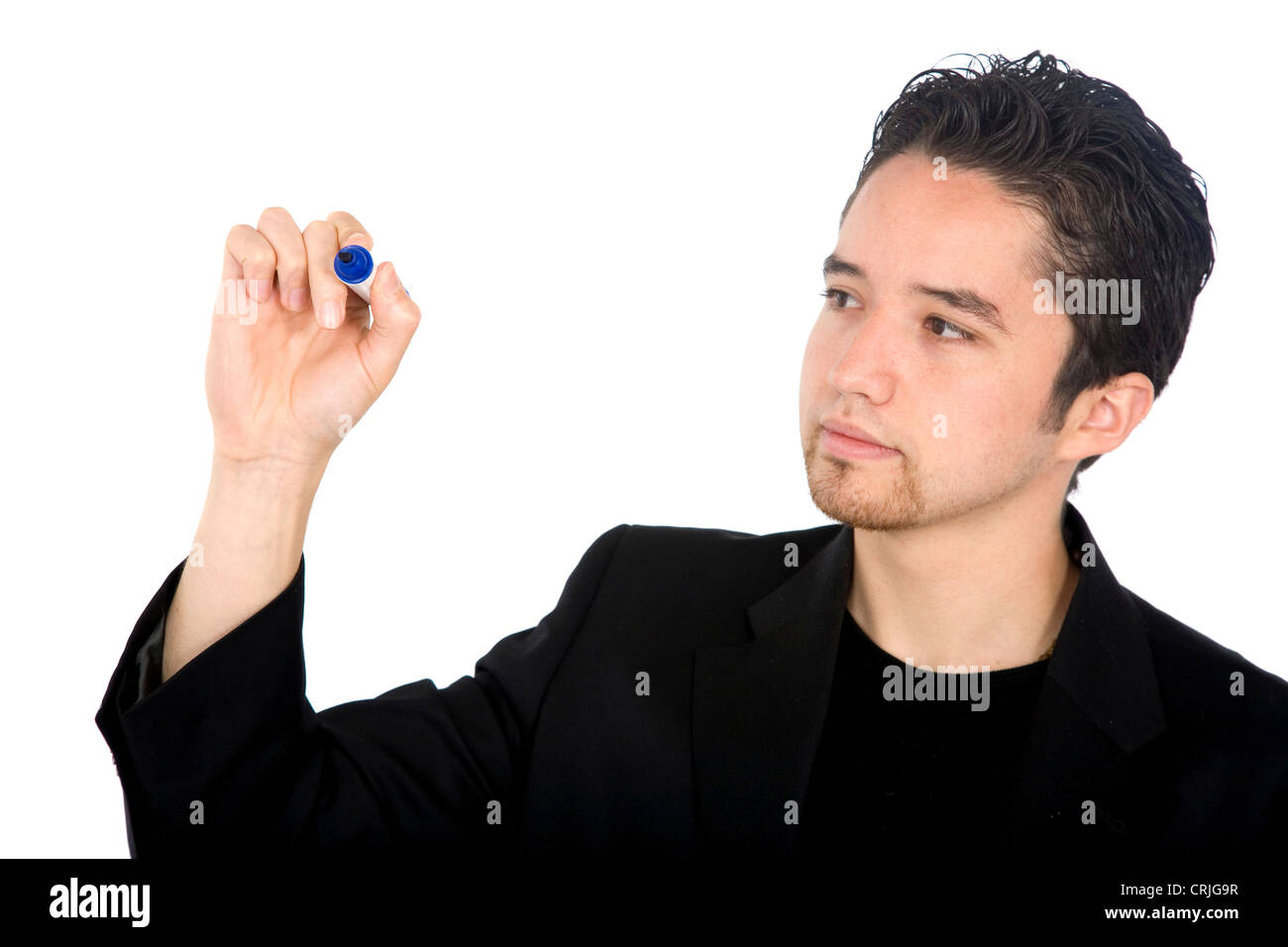 young man writing something on an imaginary glass pane in front of him ...