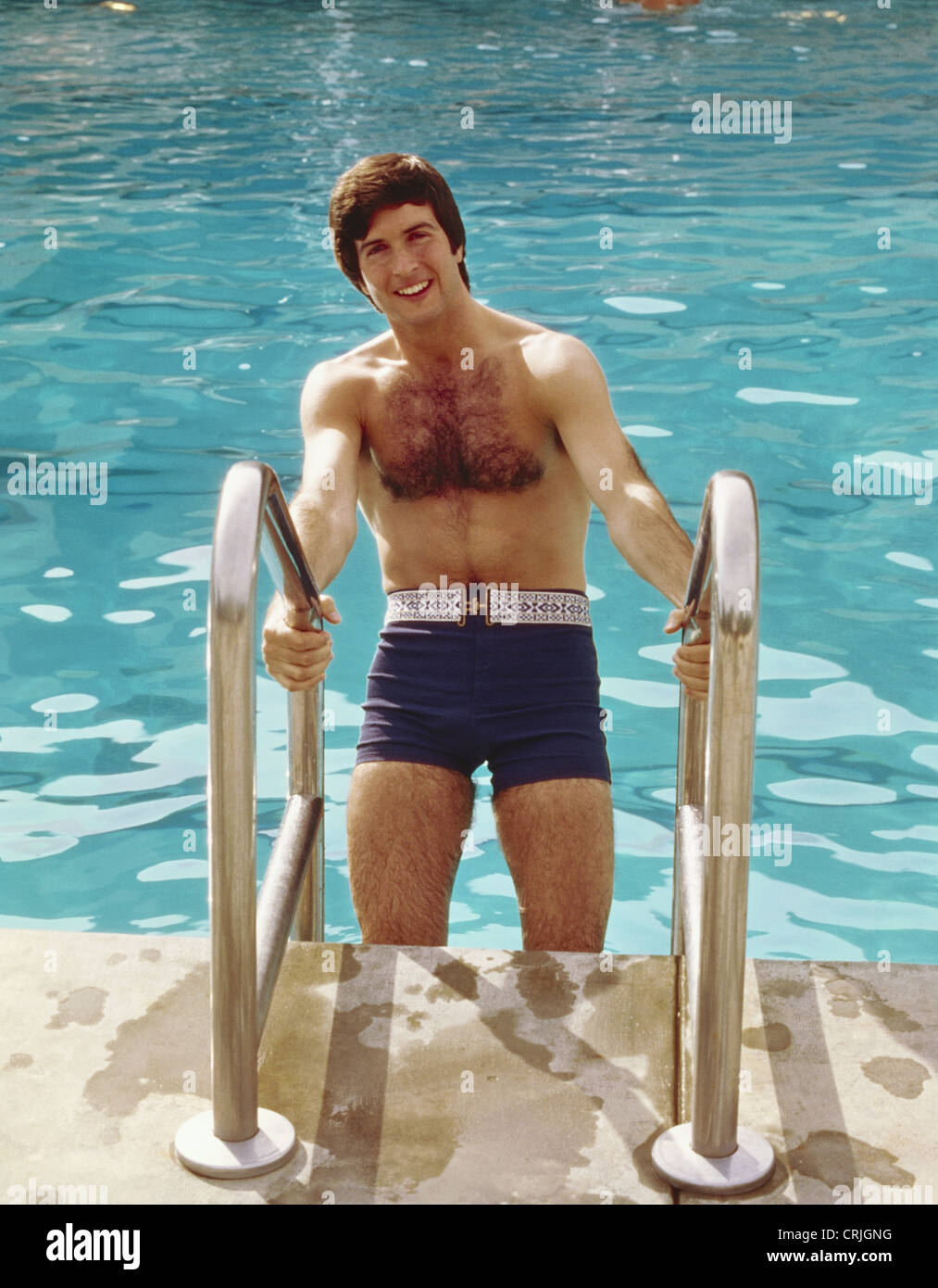 Young man coming out of swimming pool Stock Photo Alamy