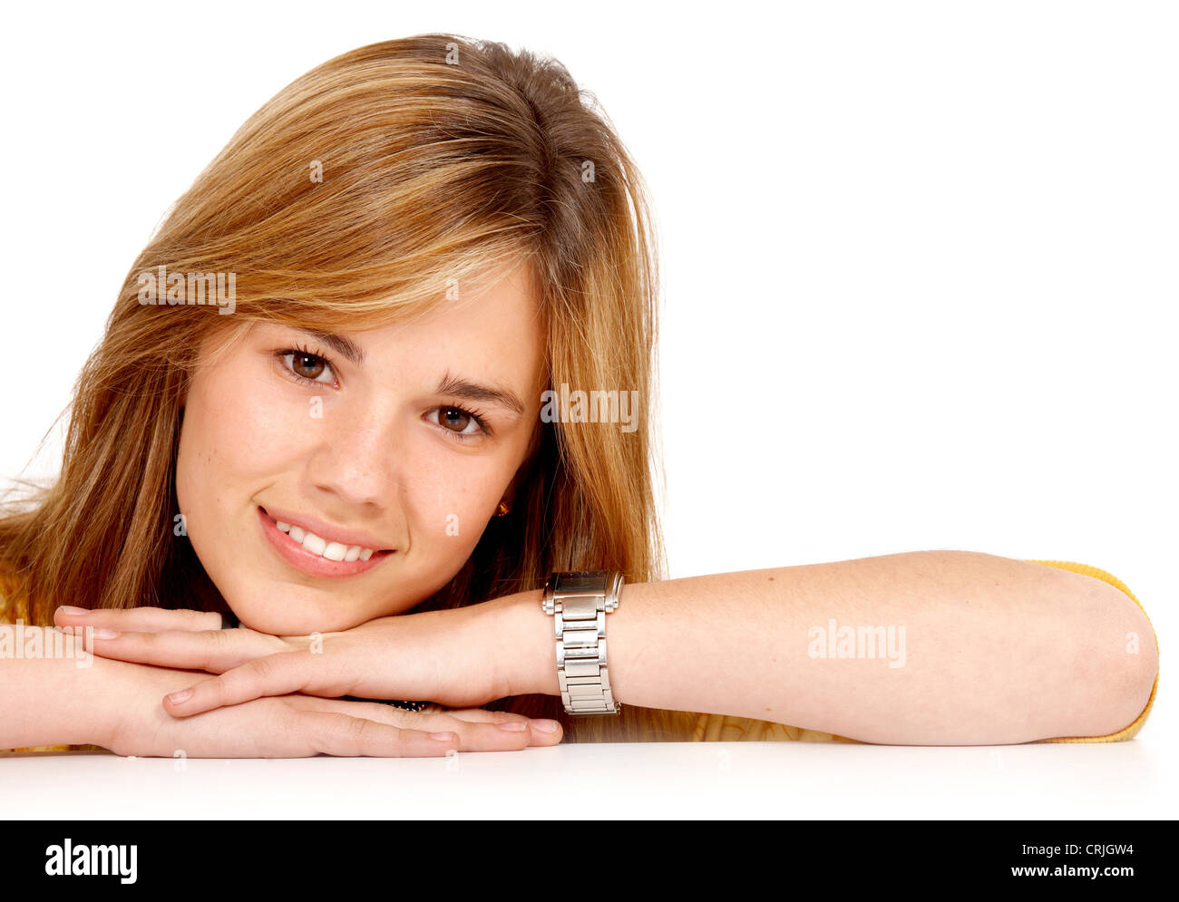 young girl laying her chin on the back of her hands with a smile Stock Photo