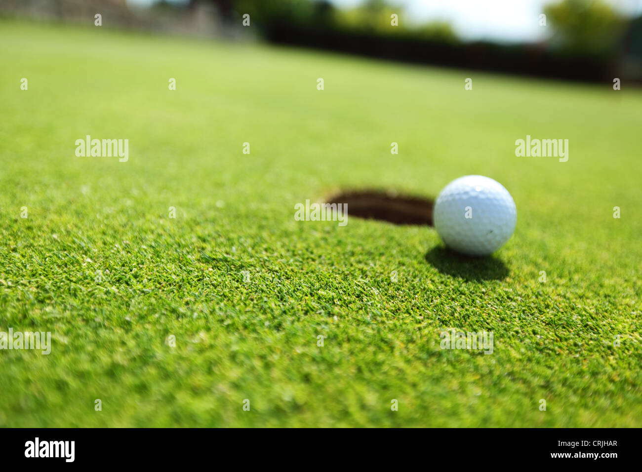 golf-ball-on-lip-of-cup-stock-photo-alamy