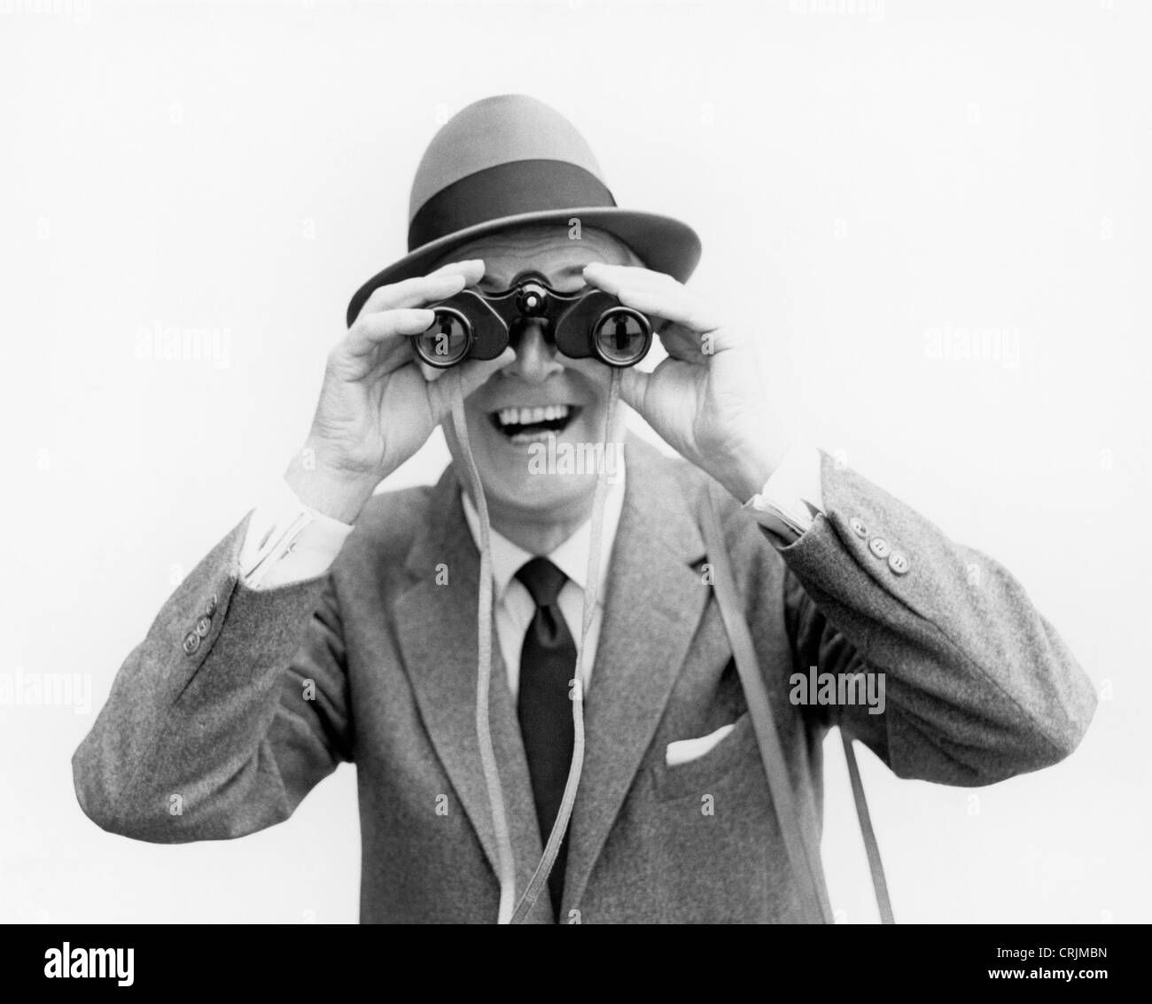 Man looking through binoculars Stock Photo