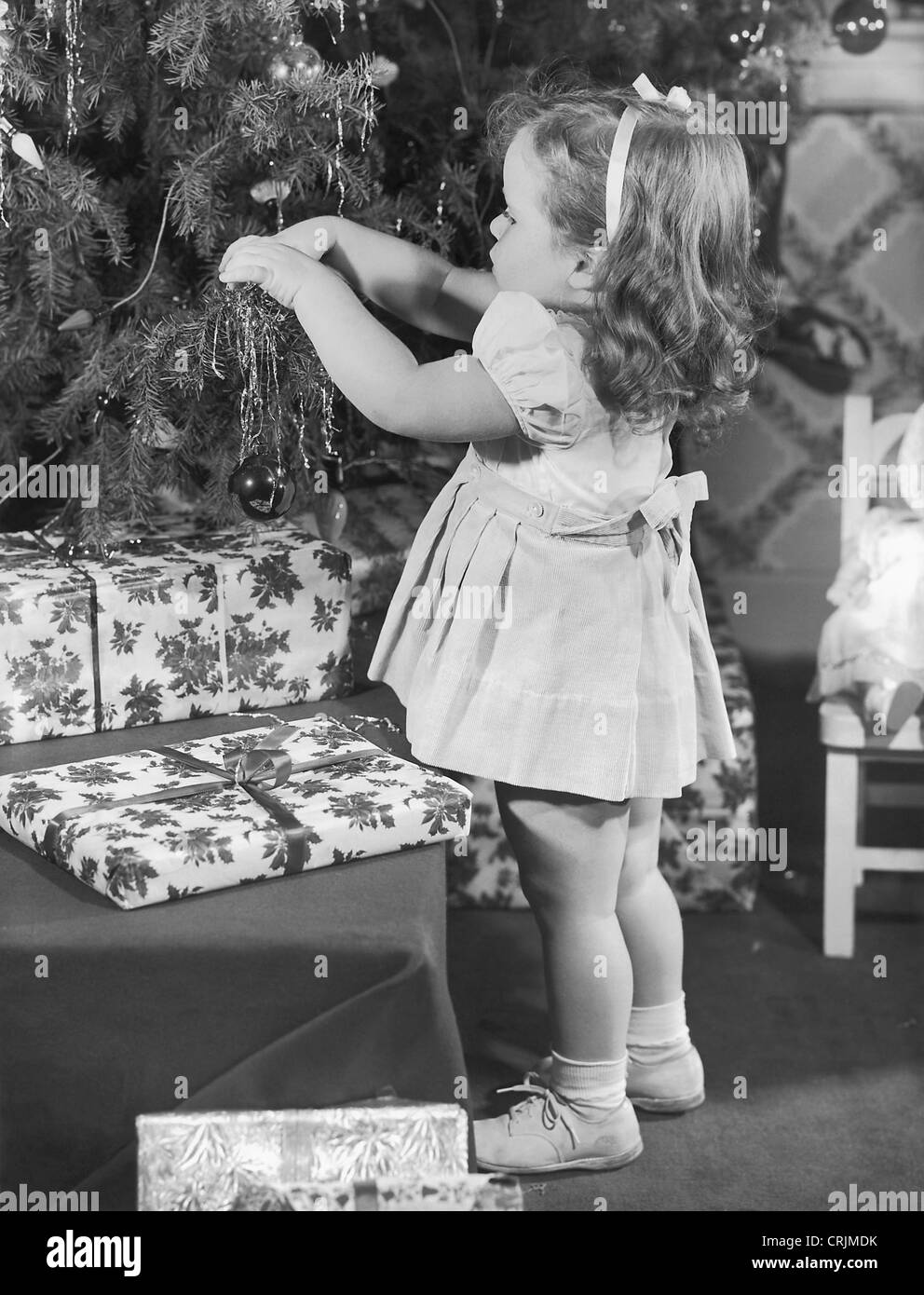 Little girl decorating Christmas tree Stock Photo