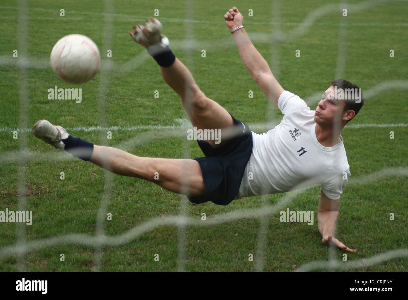 footballer playing kicking ball Stock Photo Alamy