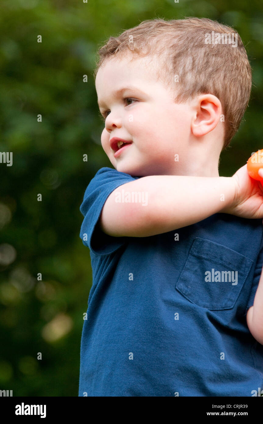 Two and a half year old boy playing in his backyard, Cincinnati, Ohio