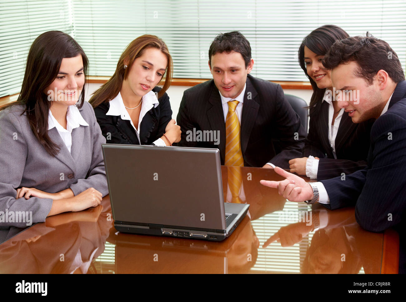 businessmen and businesswomen in a business meeting in an office smiling Stock Photo