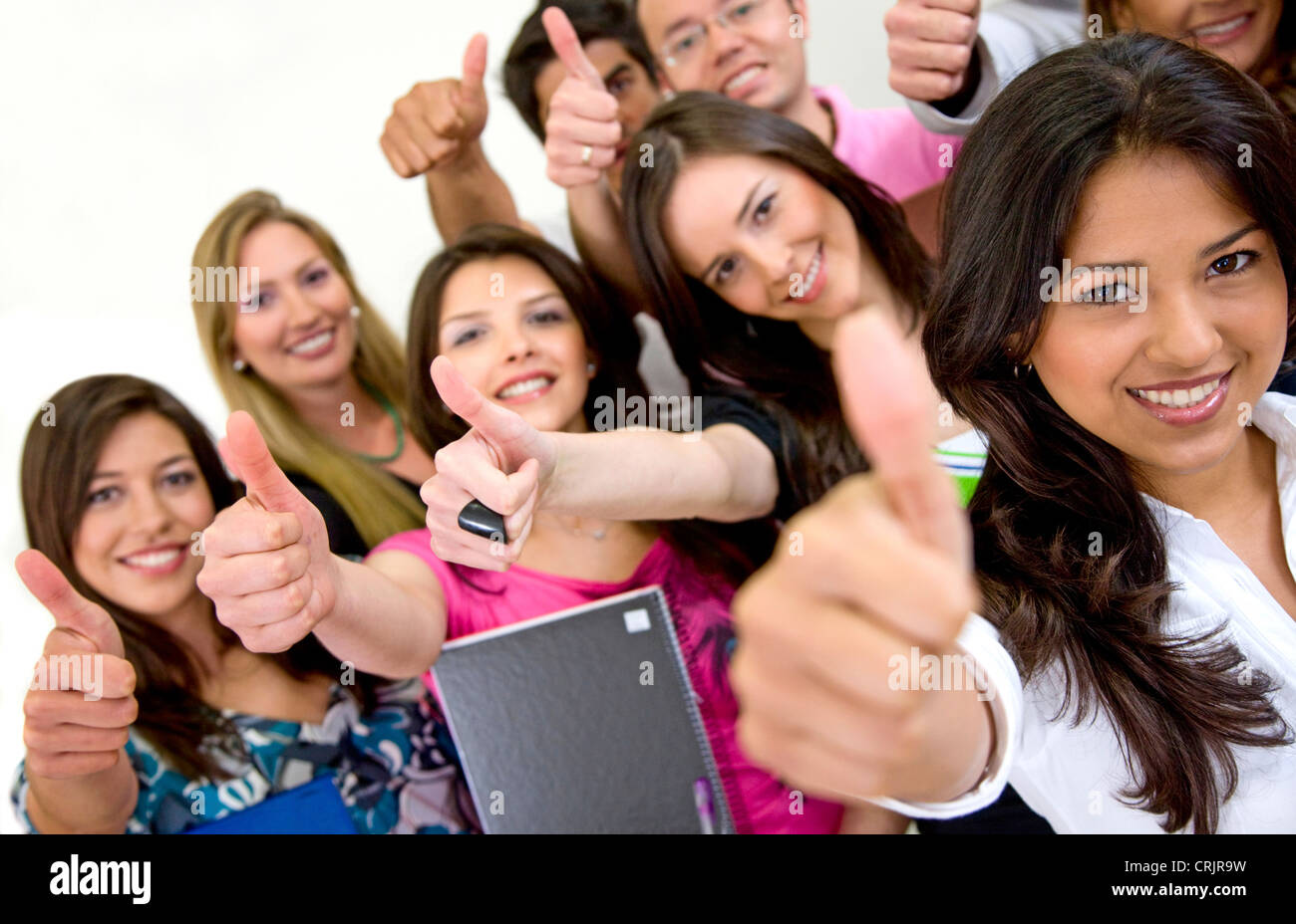 group of students smiling and doing a thumbs up sign Stock Photo