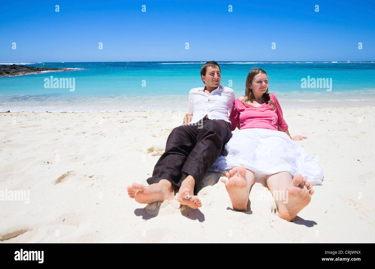 Young happy couple on white sand beach, Mauritius, Indian Ocean Stock Photo