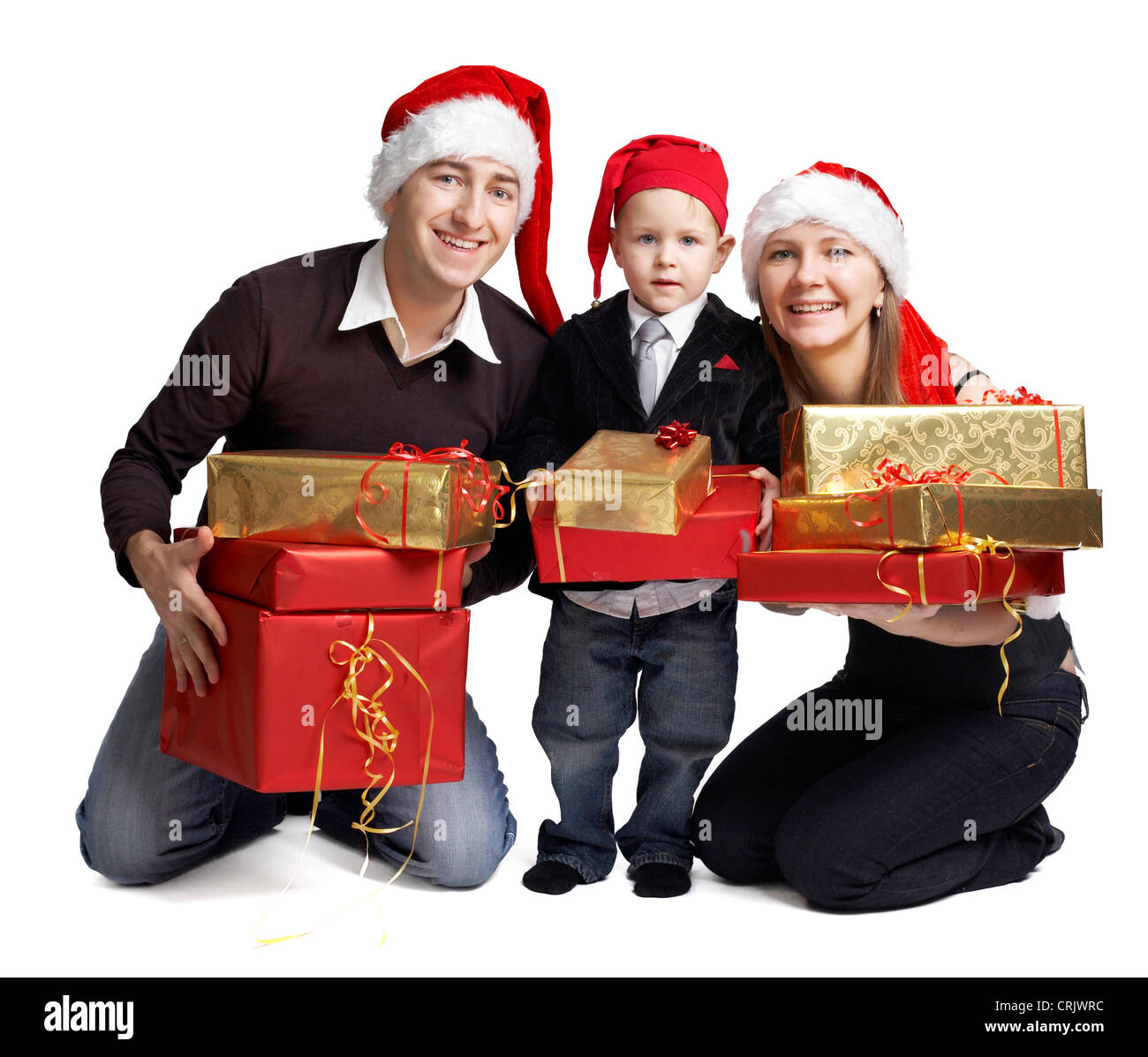 happily smiling young family with stacks of Christmas presents in their hands Stock Photo