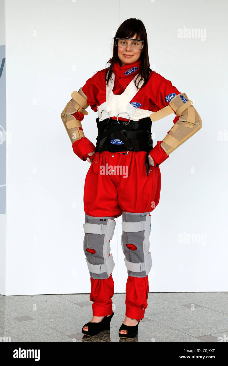 Woman dressed with an aging suit. The suit (third age suit) gives the wearer the physical experience of being old. Stock Photo