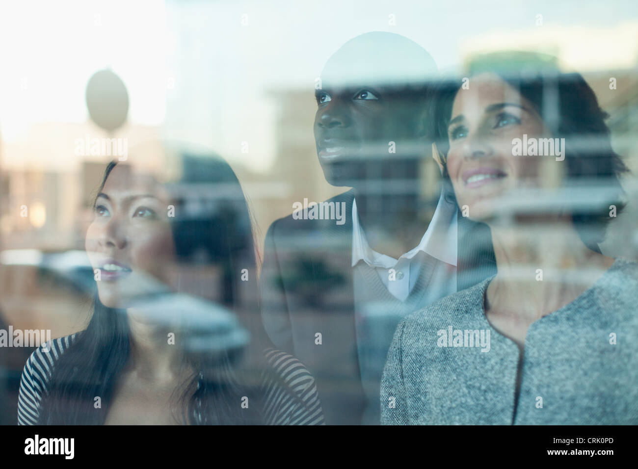 Business people looking out window Stock Photo - Alamy