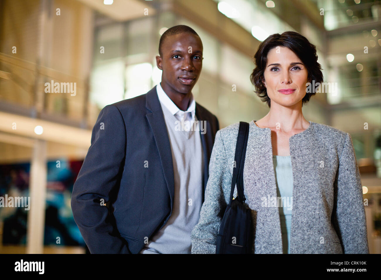 Smiling business people in lobby Stock Photo - Alamy
