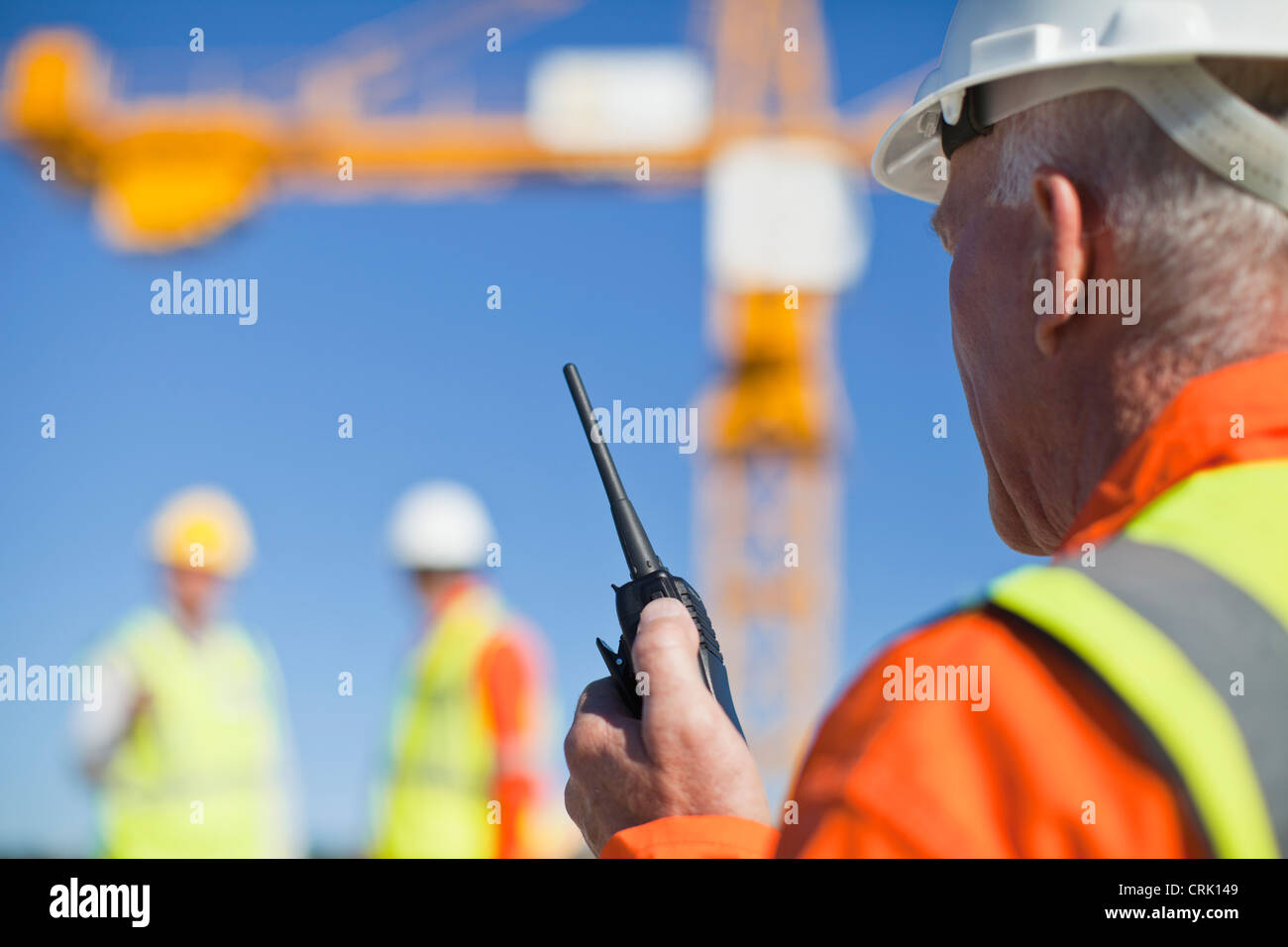 Worker using walkie talkie on site Stock Photo