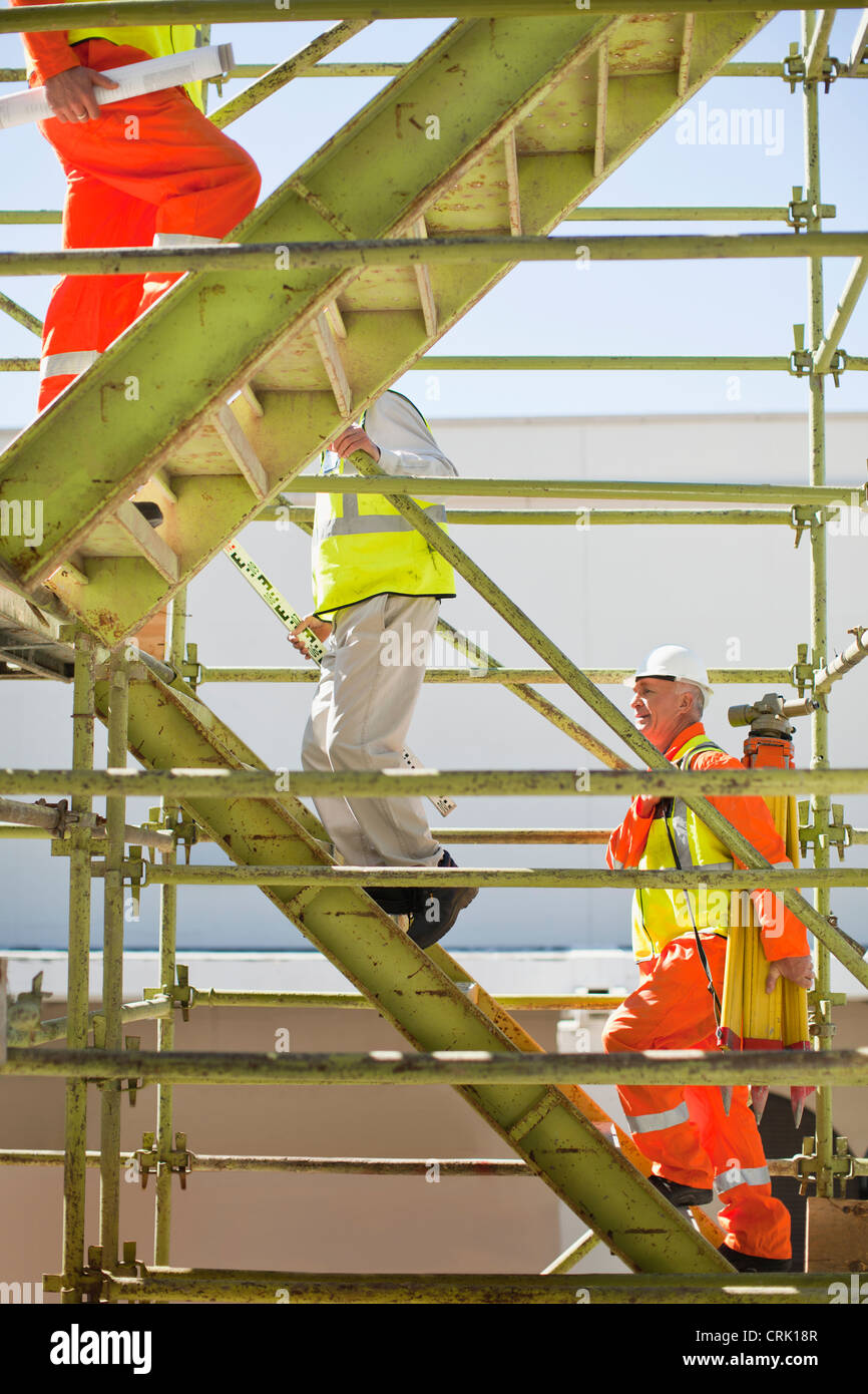 Workers climbing steps on site Stock Photo