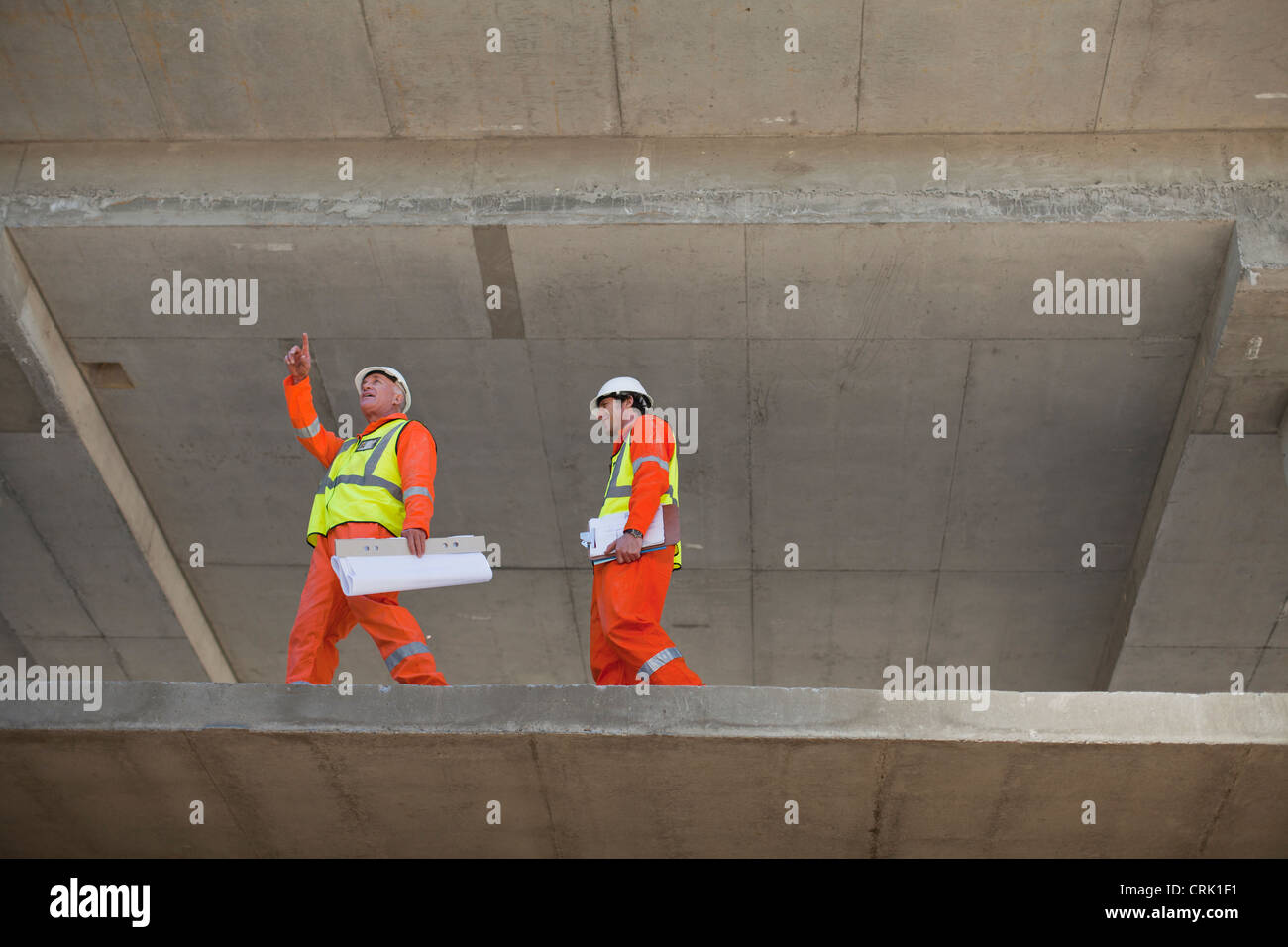 Workers walking at construction site Stock Photo Alamy