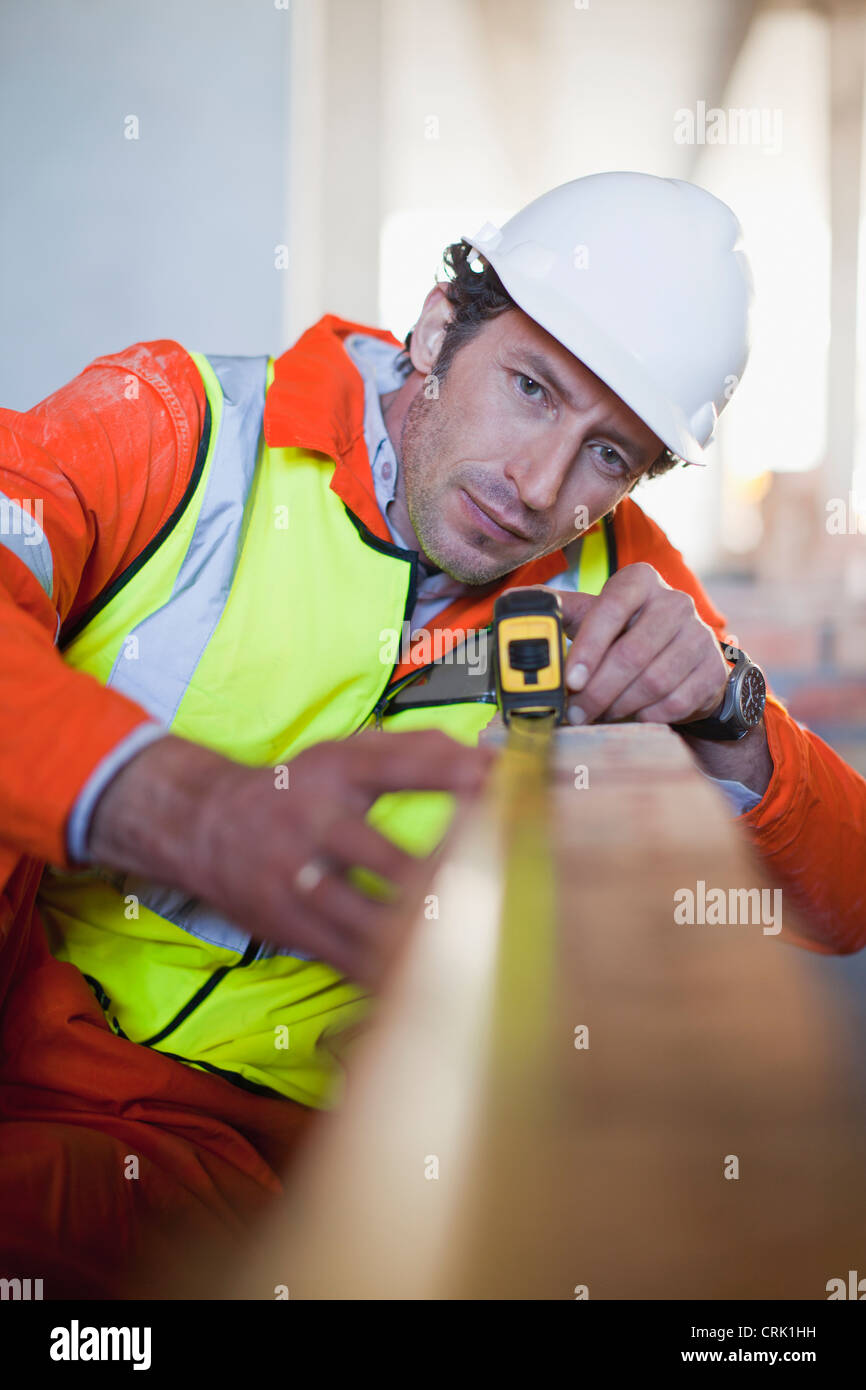 Worker measuring brick on site Stock Photo