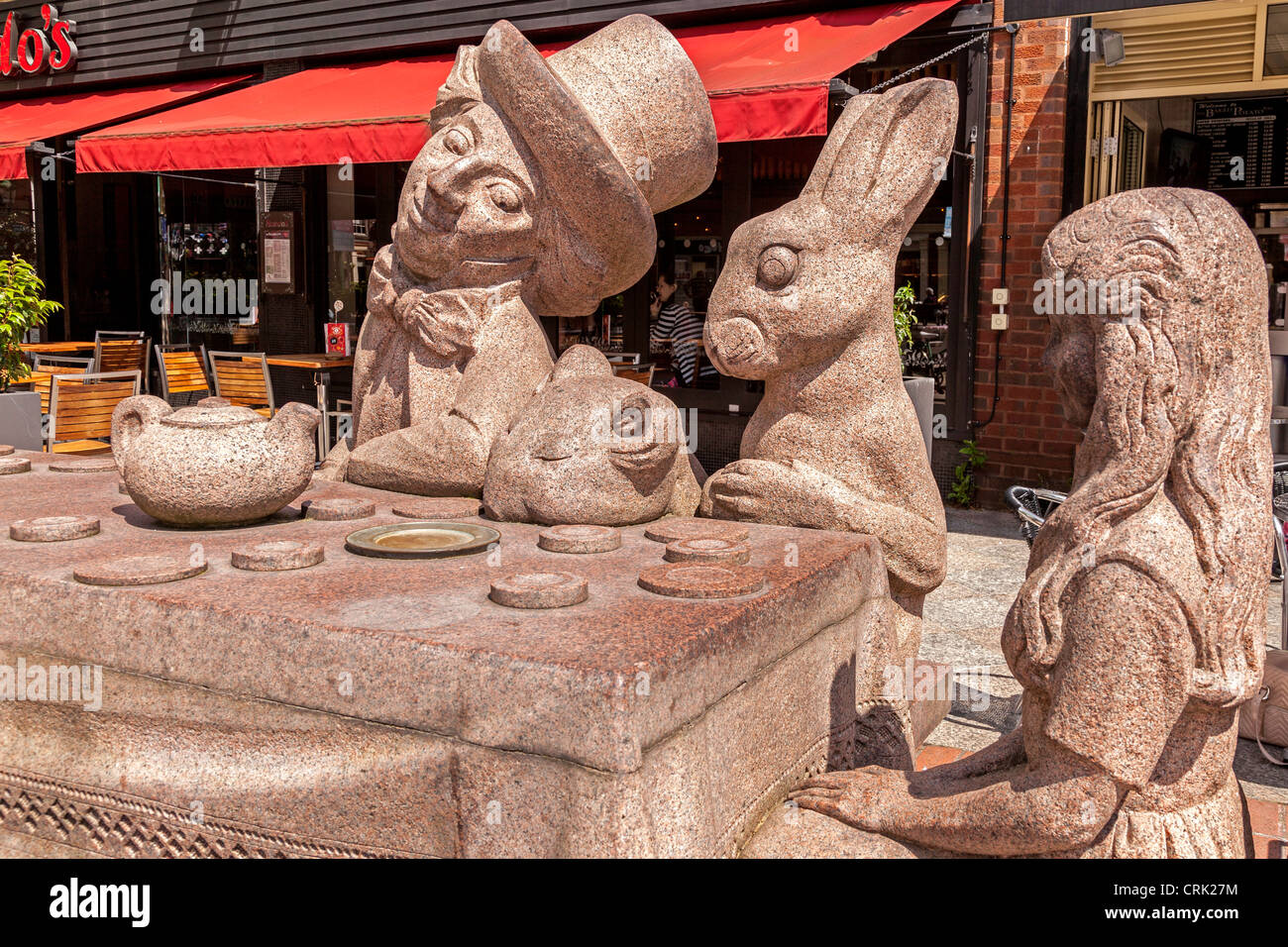 The Mad Hatter's Tea Party depicted in a statue in Golden Square Warrington shopping centre. Stock Photo