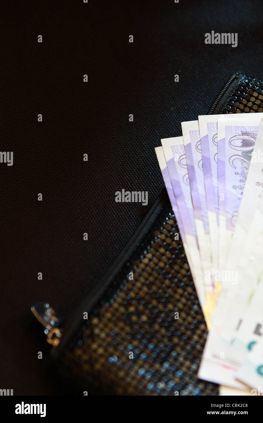 sterling notes resting on a lady's black purse Stock Photo - Alamy