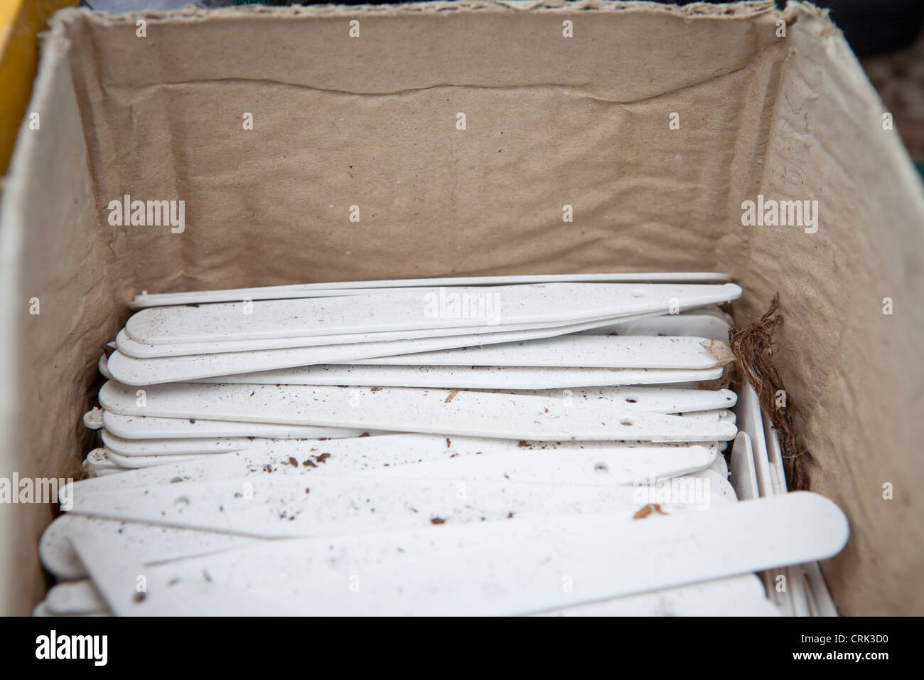A box of white plastic plant labels, coloured plant labels, angle headed labels and bed labels. Stock Photo