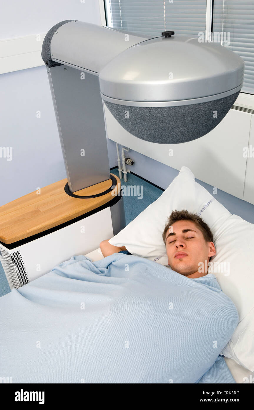 Man sleeping in hospital bed Stock Photo
